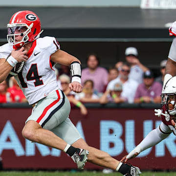 Nov 8, 2025; Starkville, Mississippi, USA; Georgia Bulldogs quarterback  Gunner Stockton (14) runs with the ball against the Mississippi State Bulldogs during the first half at Davis Wade Stadium at Scott Field. Mandatory Credit: Wesley Hale-Imagn Images