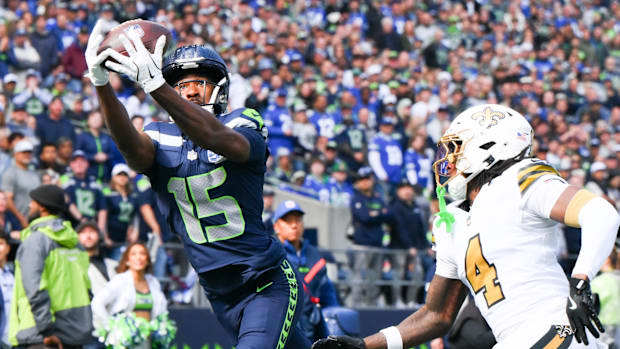 Seahawks receiver Tory Horton (15) catches a touchdown against the Saints at Lumen Field