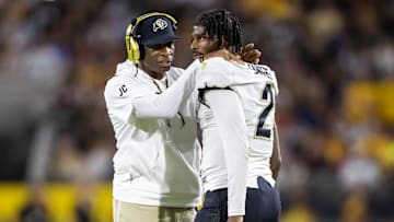 Oct 7, 2023; Tempe, Arizona, USA; Colorado Buffaloes head coach Deion Sanders reacts as he talks to son and quarterback Shedeur Sanders (2) after a penalty against the Arizona State Sun Devils in the second half at Mountain America Stadium. Mandatory Credit: Mark J. Rebilas-Imagn Images