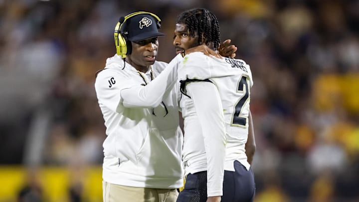 Oct 7, 2023; Tempe, Arizona, USA; Colorado Buffaloes head coach Deion Sanders reacts as he talks to son and quarterback Shedeur Sanders (2) after a penalty against the Arizona State Sun Devils in the second half at Mountain America Stadium. Mandatory Credit: Mark J. Rebilas-Imagn Images