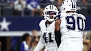 Dallas Cowboys defensive ends Donovan Ezeiruaku and Solomon Thomas celebrate after a sack against the Washington Commanders