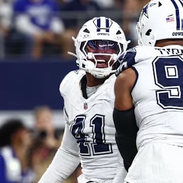 Dallas Cowboys defensive ends Donovan Ezeiruaku and Solomon Thomas celebrate after a sack against the Washington Commanders