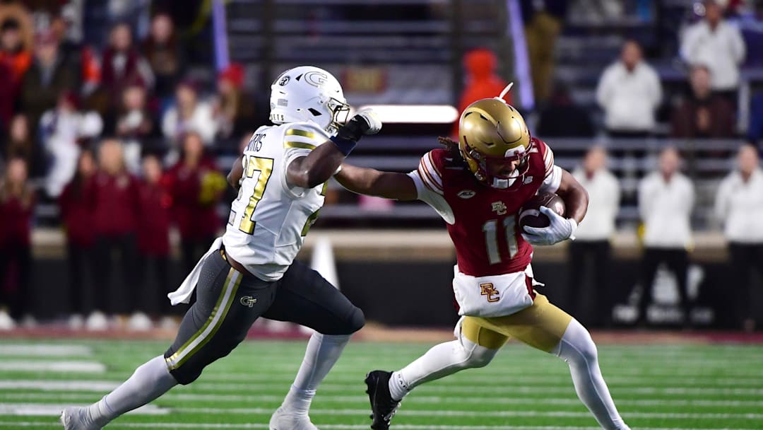 Nov 15, 2025; Chestnut Hill, Massachusetts, USA;  Boston College Eagles wide receiver Lewis Bond (11) runs with the ball while Georgia Tech Yellow Jackets defensive back Tae Harris (27) defends during the first half at Alumni Stadium. Mandatory Credit: Bob DeChiara-Imagn Images