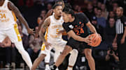 Dec 10, 2024; New York, New York, USA;  Miami Hurricanes guard Nijel Pack (24) looks to drive past Tennessee Volunteers guard Zakai Zeigler (5) in the first half at Madison Square Garden. Mandatory Credit: Wendell Cruz-Imagn Images