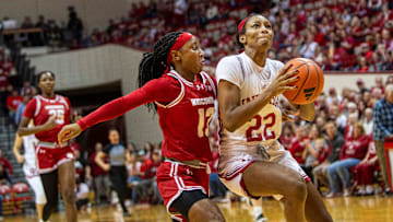 Indiana's Chloe Moore-McNeil (22) drives past Wisconsin's Ronnie Porter (13) during the Indiana versus Wisconsin women's basketball game at Simon Skjodt Assembly Hall on Saturday, Dec. 28, 2024.