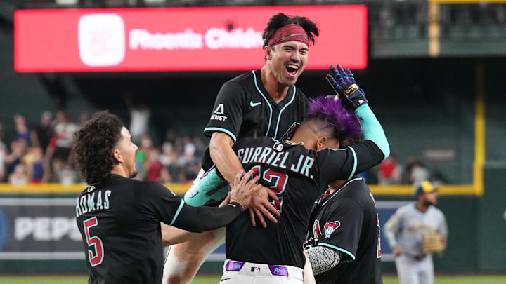 Arizona Diamondbacks outfielder Alek Thomas (5) and outfielder Corbin Carroll (7) celebrate with outfielder Lourdes Gurriel Jr. (12) after a walk-off sacrifice fly RBI by Gurriel Jr. against the Milwaukee Brewers. Arizona Diamondbacks outfielder Alek Thomas (5) and outfielder Corbin Carroll (7) celebrate with outfielder Lourdes Gurriel Jr. (12) after a walk-off sacrifice fly RBI by Gurriel Jr. against the Milwaukee Brewers.