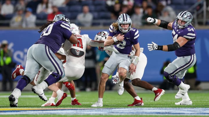 Dec 28, 2023; Orlando, FL, USA;  Kansas State Wildcats quarterback Avery Johnson (2) runs with the ball against the North Carolina State Wolfpack in the first quarter during the Pop-Tarts Bowl at Camping World Stadium. Mandatory Credit: Nathan Ray Seebeck-USA TODAY Sports