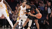 Dec 10, 2024; New York, New York, USA;  Miami Hurricanes guard Nijel Pack (24) looks to drive past Tennessee Volunteers guard Zakai Zeigler (5) in the first half at Madison Square Garden. Mandatory Credit: Wendell Cruz-Imagn Images