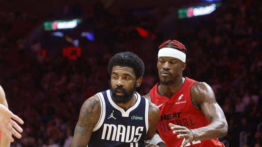 Nov 24, 2024; Miami, Florida, USA;  Miami Heat forward Jimmy Butler (22) defends Dallas Mavericks guard Kyrie Irving (11) during overtime at Kaseya Center. Mandatory Credit: Rhona Wise-Imagn Images