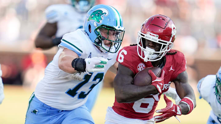 Oklahoma Sooners wide receiver Deion Burks (6) runs past Tulane Green Wave linebacker Tyler Grubbs (13) during a college football game between the University of Oklahoma Sooners (OU) and the Tulane Green Wave at Gaylord Family - Oklahoma Memorial Stadium in Norman, Okla., Saturday, Sept. 14, 2024.