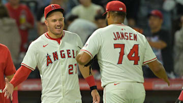 Jul 28, 2025; Anaheim, California, USA; Los Angeles Angels relief pitcher Kenley Jansen (74) is congratulated by designated hitter Mike Trout (27) after earning a save in the ninth inning against the Texas Rangers at Angel Stadium. Mandatory Credit: Jayne Kamin-Oncea-Imagn Images