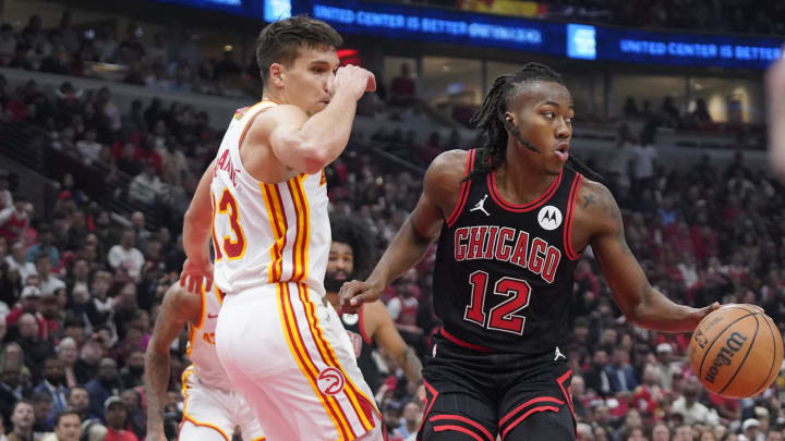 Atlanta Hawks guard Bogdan Bogdanovic (13) defends Chicago Bulls guard Ayo Dosunmu (12) during the first quarter during a play-in game of the 2024 NBA playoffs at United Center.