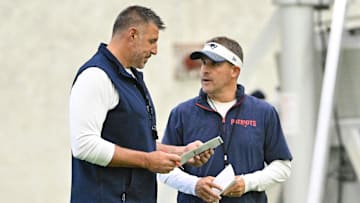 Jun 10, 2025; Foxborough, MA, USA; New England Patriots head coach Mike Vrabel (l) and offensive coordinator Josh McDaniels (r) speak to each other during minicamp held in the WIN Field House at Gillette Stadium. Mandatory Credit: Eric Canha-Imagn Images