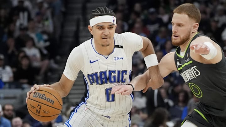 Orlando Magic guard Anthony Black (0) works around Minnesota Timberwolves guard Donte DiVincenzo (0) in the third quarter at Target Center. Orlando Magic guard Anthony Black (0) works around Minnesota Timberwolves guard Donte DiVincenzo (0) in the third quarter at Target Center.