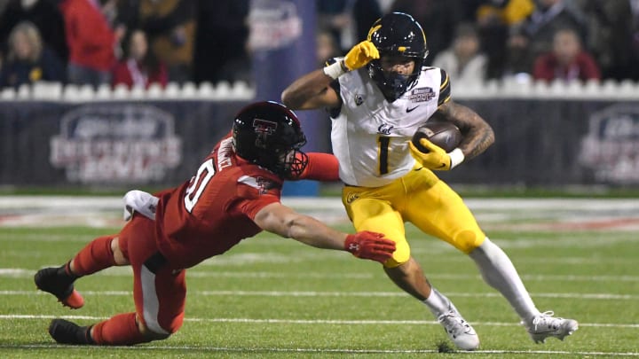 Jaydn Ott eludes a tackle in the Independence Bowl