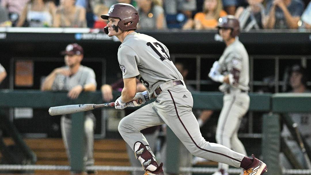 Jun 24, 2024; Omaha, NE, USA;  Texas A&M Aggies left fielder Caden Sorrell (13) doubles in a run against the Tennessee Volunteers during the 2024 CWS. Mandatory Credit: Steven Branscombe-Imagn Images