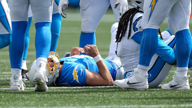 North Carolina, USA; Los Angeles Chargers quarterback Justin Herbert (10) is slow to get up after a hit against the Carolina 