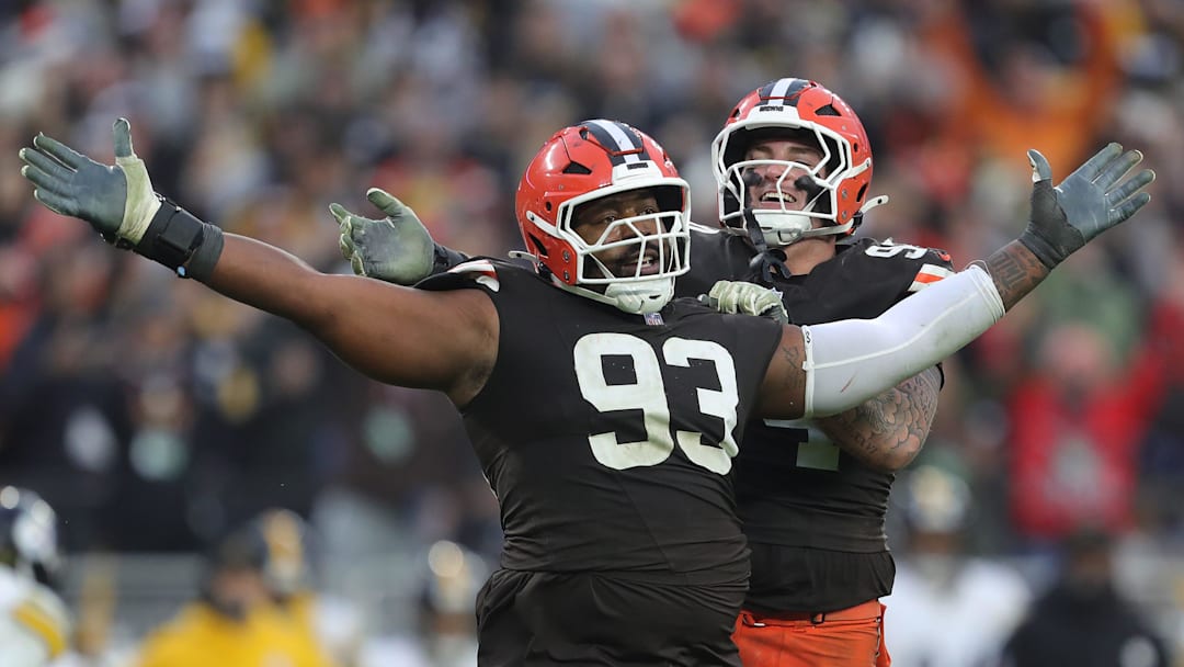 Browns defensive tackle Shelby Harris (93) celebrates with defensive tackle Mason Graham after a second-half stop, Dec. 28, 2025, in Cleveland.