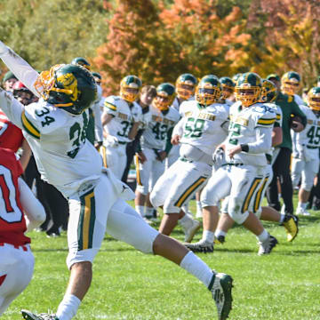 Burr and Burton's Jack McCoy tries to tip the ball out of CVU's Dylan Frere's reach during the Bulldogs' game vs the Redhawks on Saturday afternoon in Hinesburg.

Football Burr And Burton At Cvu 08oct22 9005