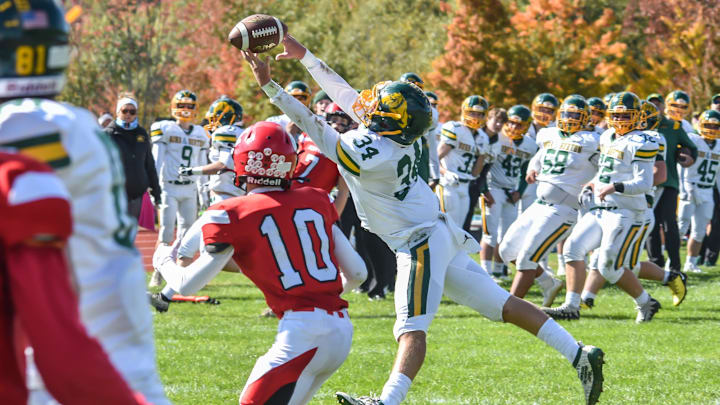 Burr and Burton's Jack McCoy tries to tip the ball out of CVU's Dylan Frere's reach during the Bulldogs' game vs the Redhawks on Saturday afternoon in Hinesburg.

Football Burr And Burton At Cvu 08oct22 9005