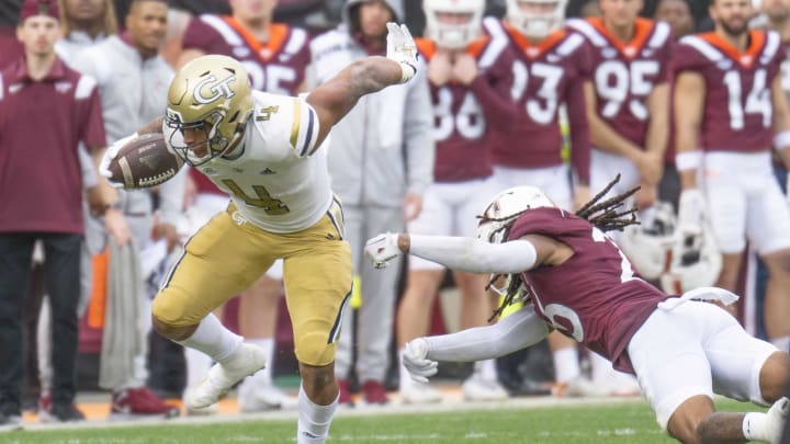 Nov 5, 2022; Blacksburg, Virginia, USA; Georgia Tech Yellow Jackets running back Dontae Smith (4)) avoids tackle by Virginia Tech Hokies defensive back Jalen Stroman (26) in the first half at Lane Stadium. Mandatory Credit: Lee Luther Jr.-USA TODAY Sports