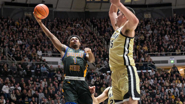 Nov 10, 2023; West Lafayette, Indiana, USA; Morehead State Eagles guard Jerone Morton (1) shoots the ball in front of Purdue Boilermakers center Zach Edey (15) during the fist half at Mackey Arena. Mandatory Credit: Marc Lebryk-Imagn Images Nov 10, 2023; West Lafayette, Indiana, USA; Morehead State Eagles guard Jerone Morton (1) shoots the ball in front of Purdue Boilermakers center Zach Edey (15) during the fist half at Mackey Arena. Mandatory Credit: Marc Lebryk-Imagn Images