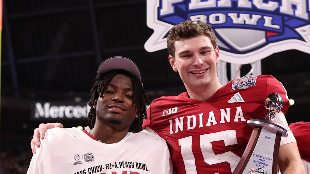 Jan 9, 2026; Atlanta, GA, USA; Indiana Hoosiers quarterback Fernando Mendoza (15) and Indiana Hoosiers defensive back D'Angelo Ponds (5) hold their trophies after the 2025 Peach Bowl and semifinal game of the College Football Playoff at Mercedes-Benz Stadium. Mandatory Credit: Brett Davis-Imagn Images