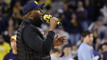 Jan 27, 2024; Ann Arbor, Michigan, USA; Michigan Wolverines head football coach Sherrone Moore addresses the basketball crowd during a time out against the Iowa Hawkeyes at Crisler Center. Mandatory Credit: Rick Osentoski-USA TODAY Sports