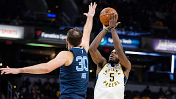 Oct 14, 2024; Indianapolis, Indiana, USA; Indiana Pacers forward Jarace Walker (5) shoots the ball while Memphis Grizzlies center Jay Huff (30) defends in the second half at Gainbridge Fieldhouse. Mandatory Credit: Trevor Ruszkowski-Imagn Images