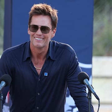 Aug 8, 2025; Foxborough, Massachusetts, USA; Retired New England Patriot Hall of Famer Tom Brady speaks during a statue unveiling before a game against the Washington Commanders at Gillette Stadium. Mandatory Credit: Paul Rutherford-Imagn Images