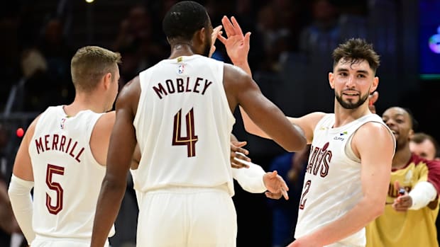 Cleveland Cavaliers guard Ty Jerome (2) celebrates after hitting a three point basket with guard Sam Merrill (5) and forward 