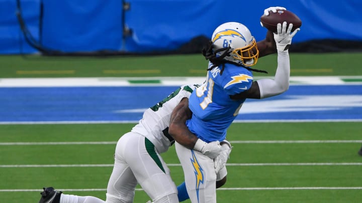 Nov 22, 2020; Inglewood, California, USA;  Los Angeles Chargers wide receiver Mike Williams (81) catches a pass against New York Jets cornerback Arthur Maulet (23) during the third quarter at SoFi Stadium.  