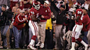 Oklahoma Sooners head coach Bob Stoops celebrates an interception with defensive tackle Gerald McCoy (93) during the game against the Texas Tech Red Raiders at Gaylord Family Oklahoma Memorial Stadium in Norman in 2008.