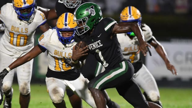 Venice High wide receiver Winston Watkins (#1) is pursued by Miami Northwestern defenders. 