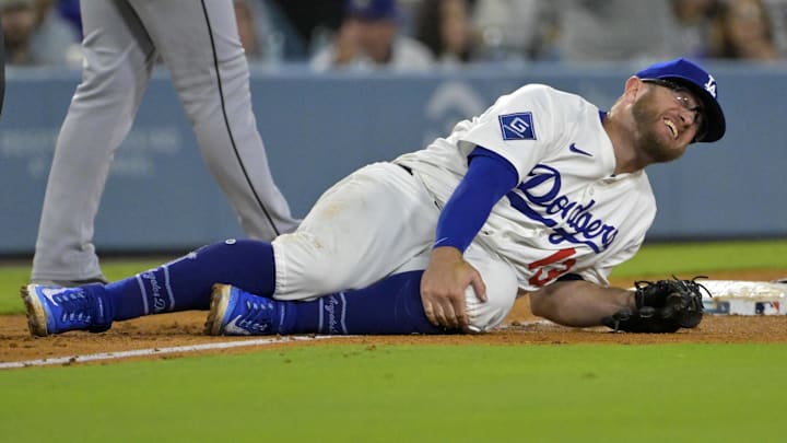 Los Angeles Dodgers third baseman Max Muncy grabs his knee after being injured while making a defensive play on July 2, 2025.