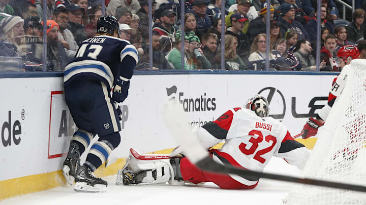 Mar 17, 2026; Columbus, Ohio, USA; Carolina Hurricanes goalie Brandon Bussi (32) falls to the ice after a collision with Columbus Blue Jackets defenseman Danton Heinen (43) during the second period at Nationwide Arena. Mandatory Credit: Russell LaBounty-Imagn Images