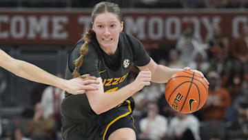 Jan 30, 2025; Austin, Texas, USA; Missouri Tigers guard Grace Slaughter (0) drives to the basket while defended by Texas Longhorns guard Shay Holle (10) during the second half at Moody Center. Mandatory Credit: Scott Wachter-Imagn Images