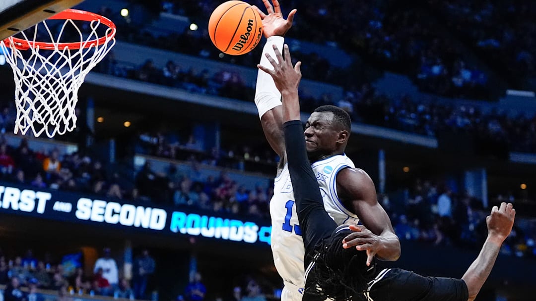 Mar 20, 2025; Denver, CO, USA; Brigham Young Cougars center Keba Keita (13) shoots the ball against VCU Rams forward Christian Fermin (21) during the first half in the first round of the NCAA Tournament at Ball Arena. Mandatory Credit: Ron Chenoy-Imagn Images