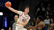 Mar 12, 2025; Charlotte, NC, USA; Stanford Cardinal forward Maxime Raynaud (42) passes the ball as California Golden Bears center Mady Sissoko (12) defends in the second half at Spectrum Center.