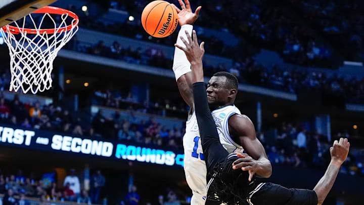 Mar 20, 2025; Denver, CO, USA; Brigham Young Cougars center Keba Keita (13) shoots the ball against VCU Rams forward Christian Fermin (21) during the first half in the first round of the NCAA Tournament at Ball Arena. Mandatory Credit: Ron Chenoy-Imagn Images