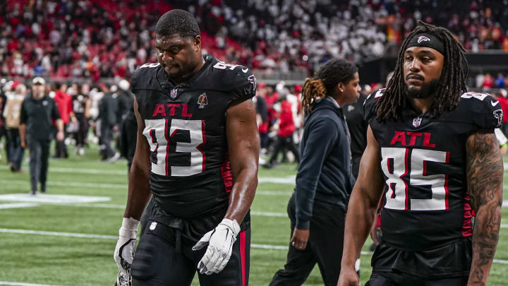 Dec 10, 2023; Atlanta, Georgia, USA; Atlanta Falcons defensive tackle Calais Campbell (93) and tight end MyCole Pruitt (85) leave the field after being defeated by the Tampa Bay Buccaneers at Mercedes-Benz Stadium. Mandatory Credit: Dale Zanine-USA TODAY Sports