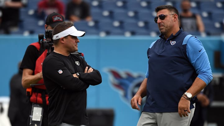 Sep 25, 2022; Nashville, Tennessee, USA; Las Vegas Raiders head coach Josh McDaniels (left) talks with Tennessee Titans head coach Mike Vrabel (right) before the game at Nissan Stadium. 