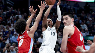 Mar 7, 2025; Dallas, Texas, USA;  Dallas Mavericks guard Brandon Williams (10) shoots during the second half as Memphis Grizzlies forward Jaylen Wells (0) and Memphis Grizzlies center Zach Edey (14) defend at American Airlines Center. Mandatory Credit: Kevin Jairaj-Imagn Images