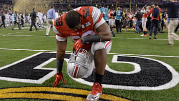 Jan 12, 2015; Arlington, TX, USA; Ohio State Buckeyes defensive lineman Donovan Munger (52) reacts to the win over Oregon Ducks in the 2015 CFP National Championship Game at AT&T Stadium. Ohio State won 42-20.