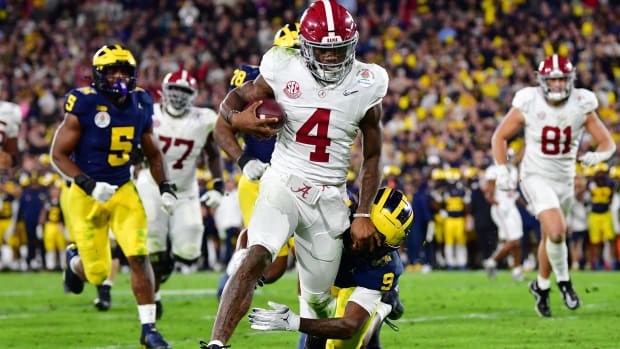 Jan 1, 2024; Pasadena, CA, USA; Alabama Crimson Tide quarterback Jalen Milroe (4) runs against Michigan Wolverines defensive back Rod Moore (9) in overtime in the 2024 Rose Bowl college football playoff semifinal game at Rose Bowl. Mandatory Credit: Gary A. Vasquez-USA TODAY Sports