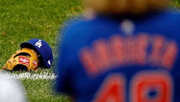 A Dodgers hat and glove lay on the ground before Game 2 of the 2016 NLCS playoff baseball series between the Chicago Cubs and the Los Angeles Dodgers at Wrigley Field on Oct. 16, 2016.