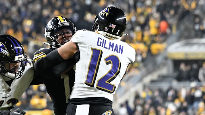 Jan 4, 2026; Pittsburgh, Pennsylvania, USA; Baltimore Ravens safety Alohi Gilman (12) and linebacker Kyle van Noy (53) tackle Pittsburgh Steelers running back Kenneth Gainwell (14) during the second half at Acrisure Stadium. Mandatory Credit: Barry Reeger-Imagn Images