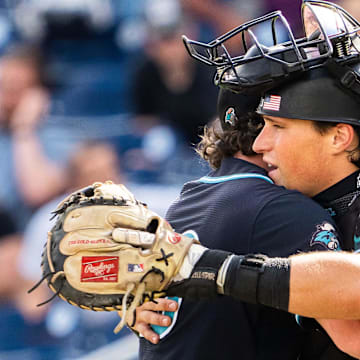 Jun 18, 2025; Omaha, Neb, USA; Coastal Carolina Chanticleers pitcher Dominick Carbone (40) and catcher Caden Bodine (17) embrace after defeating the Louisville Cardinals at Charles Schwab Field. 