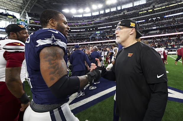 Dallas Cowboys linebacker Micah Parsons speaks with Washington Commanders head coach Dan Quinn