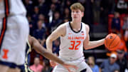 Mar 7, 2025; Champaign, Illinois, USA;  Illinois Fighting Illini guard Kasparas Jakucionis (32) looks to pass during the first half against the Purdue Boilermakers at State Farm Center. Mandatory Credit: Ron Johnson-Imagn Images